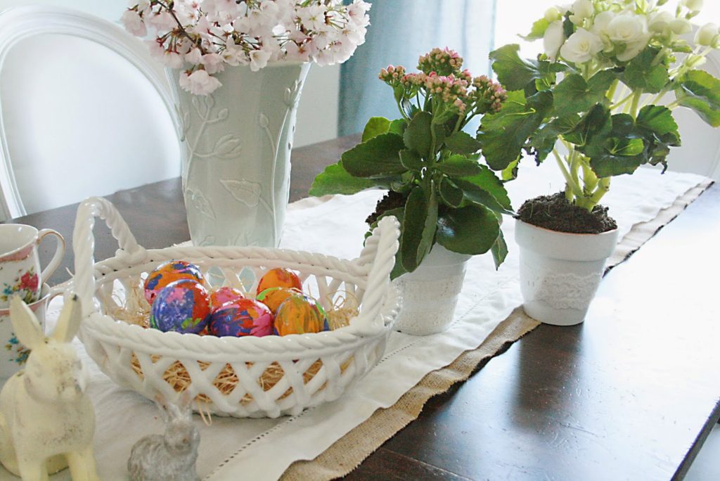 easter egg decorating table with spring flowers, easter decorating