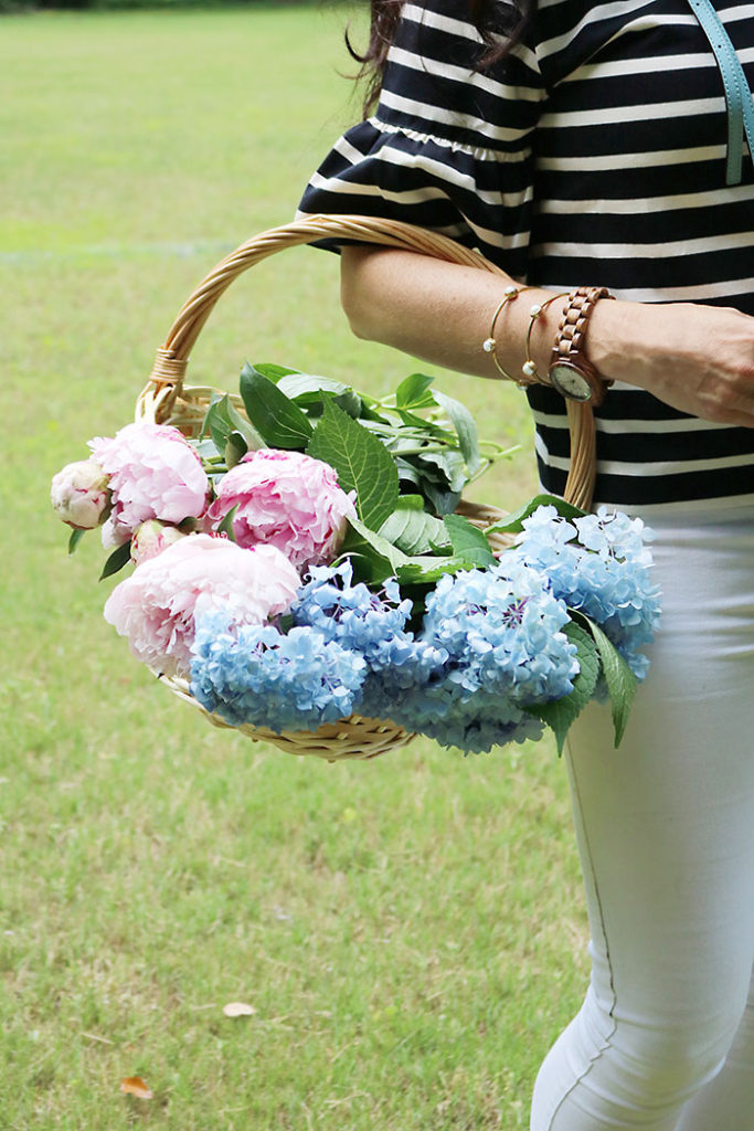 wooden-watch-holding-a-basket-of-flowers