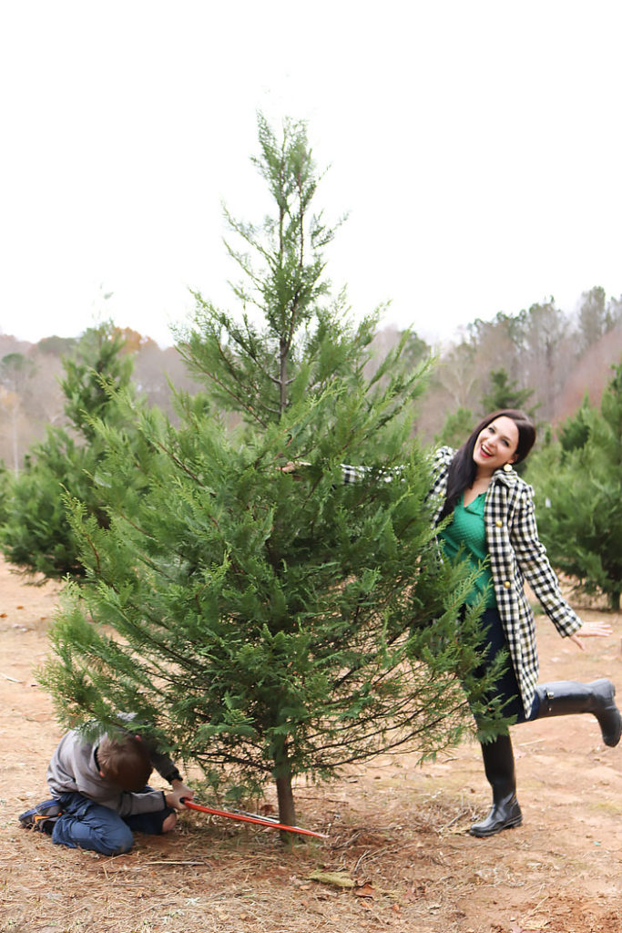 cutting-christmas-tree-down-posing, cutting our christmas tree outfit, southern tree farm, oxford coat, jcrew, hunter boots
