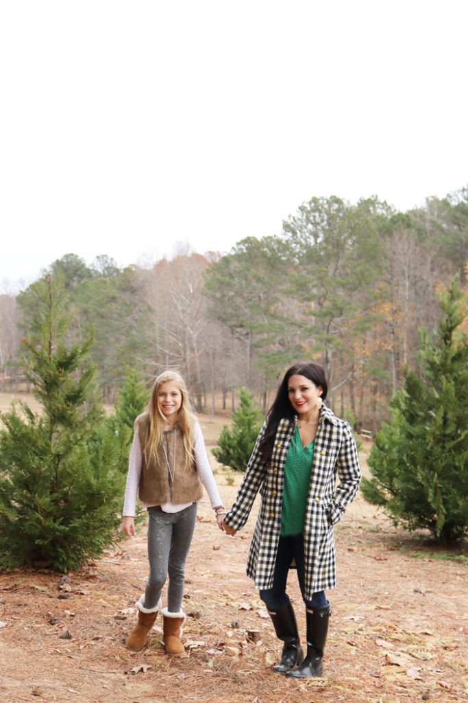 cutting-down-christmas-tree-mother-and-daugher