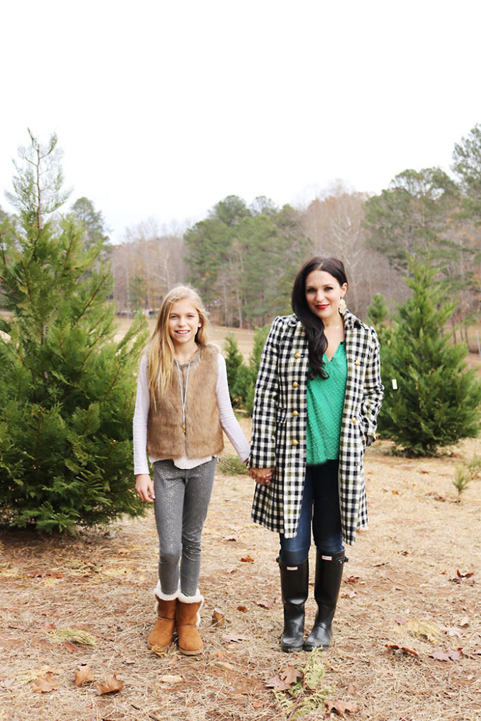 cutting-down-christmas-tree-mother-daughter, cutting down christmas tree family photography, christmas tree outfit, tree farm