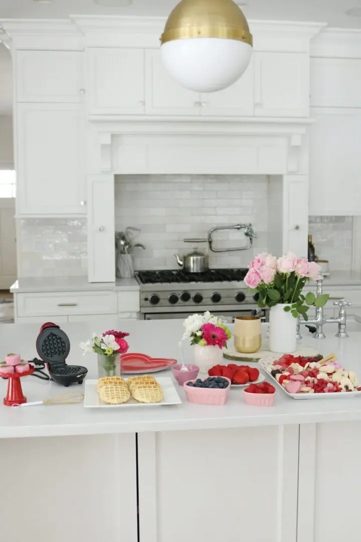 Bring Valentine's Day Home this year!  Put together a Valentine's waffle bar and breakfast of hearts and a charcuterie board with heart shaped chocolate, cinnamon lips and macrons!  So many fun Valentine's Day ideas to share with your family || Darling Darleen Top Lifestyle Blogger #ctblogger #darlingdarleen #valentinesday