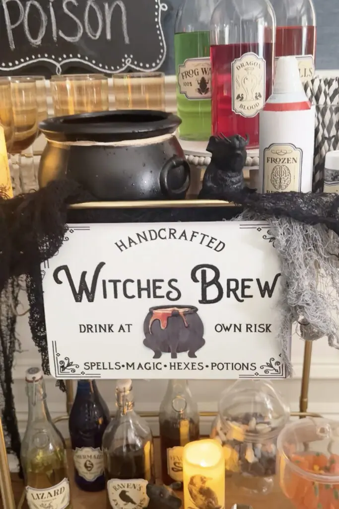 Transform Your Home into a Witch’s Haven! A Halloween-themed display with a cauldron, potion bottles, candles, and a sign reading "Handcrafted Witches Brew: Drink at Own Risk.